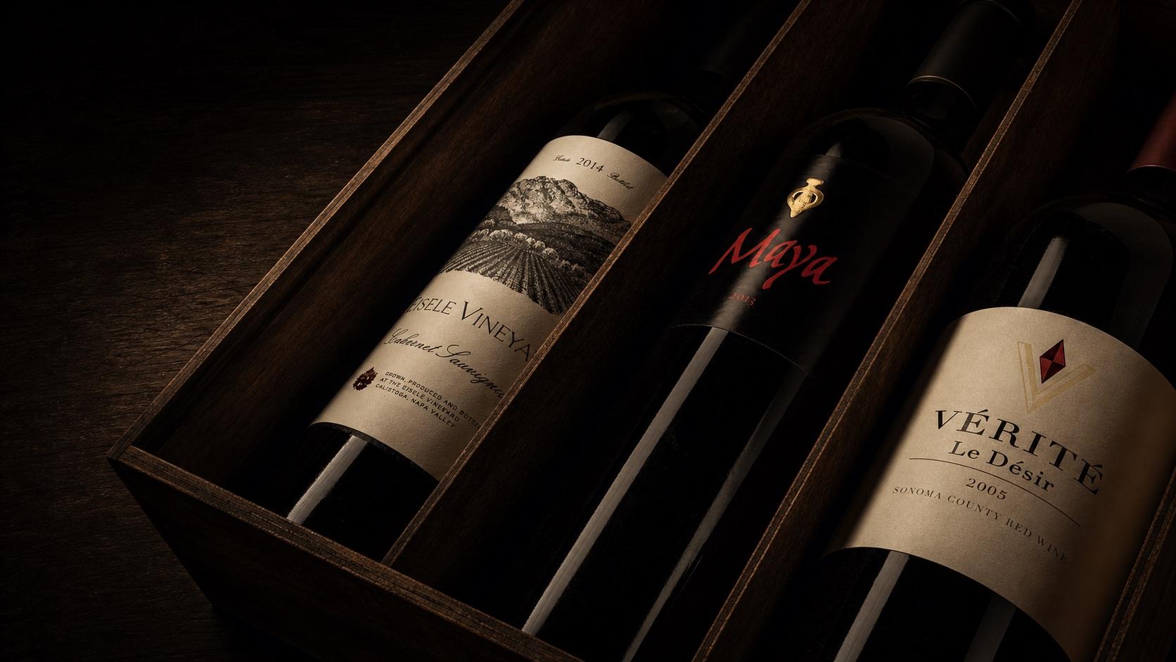 Three rare wine bottles presented in a wooden cellar case